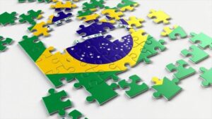 peças de quebra-cabeça formam imagem da bandeira do Brasil