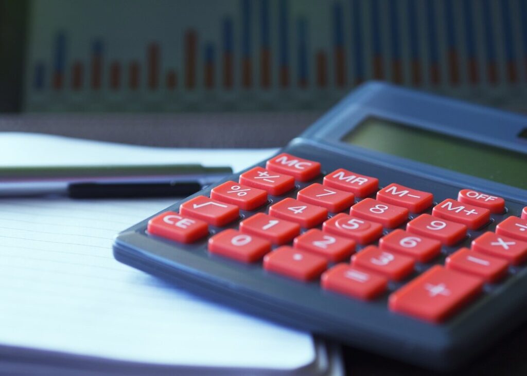 Imagem representando juros, mostrando uma calculadora e dados financeiros.
